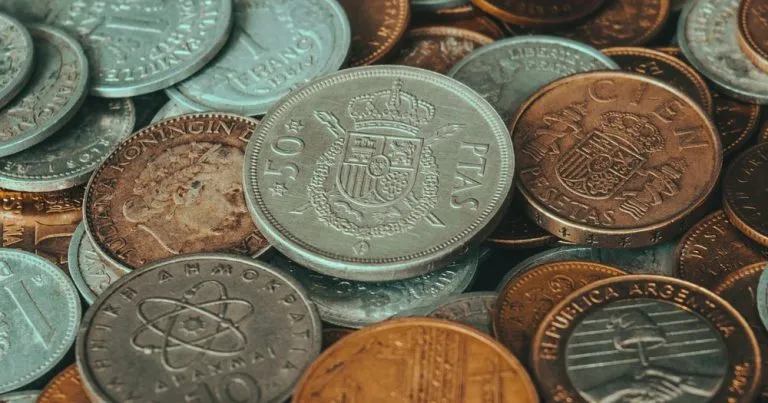 Graded Coins vs. Raw Bullion: When Grading Is Worth It (and When It Is a Tax)